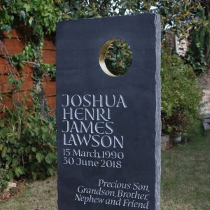 Slate Headstone golden colour circular hole in it