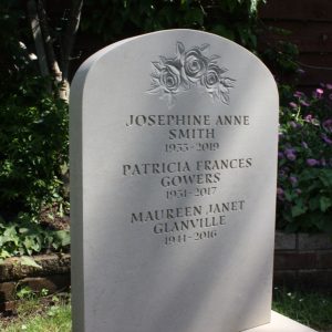 white Portland Limestone gravestone memorial in graveyard