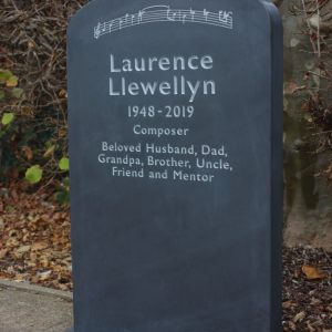 Slate Headstone with piano keys on it and musical notes